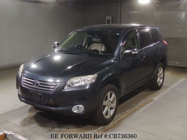 A grey JDM sports car speeding down a highway at night.