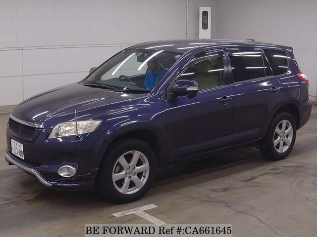 A grey JDM sports car speeding down a highway at night.