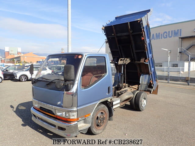 A grey JDM sports car speeding down a highway at night.