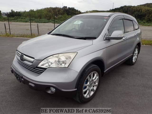 A grey JDM sports car speeding down a highway at night.