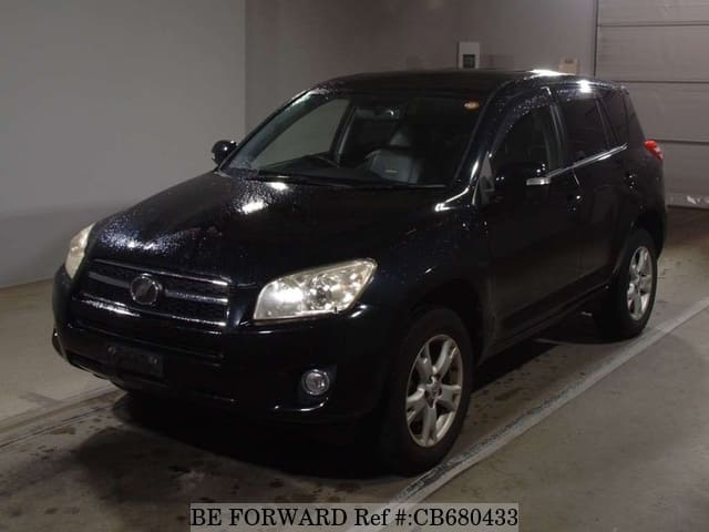 A grey JDM sports car speeding down a highway at night.