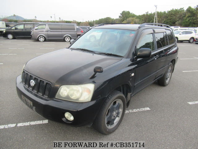 A grey JDM sports car speeding down a highway at night.