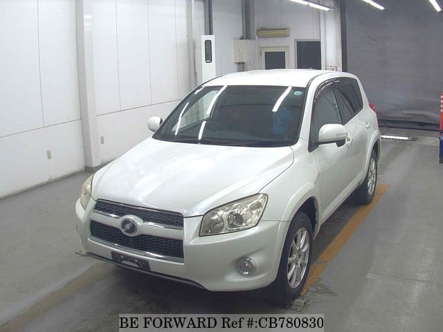A grey JDM sports car speeding down a highway at night.