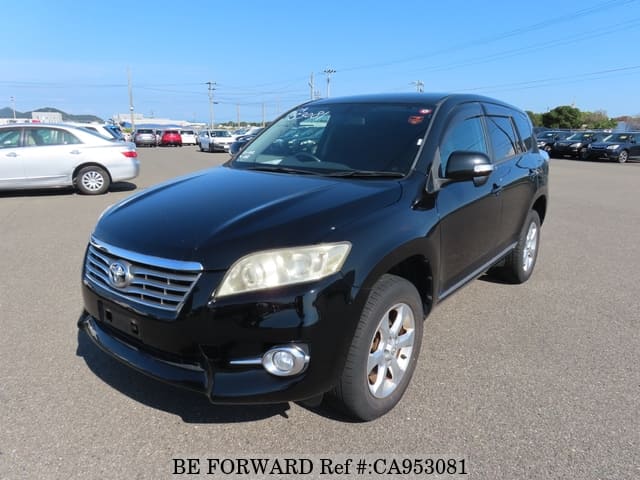 A grey JDM sports car speeding down a highway at night.