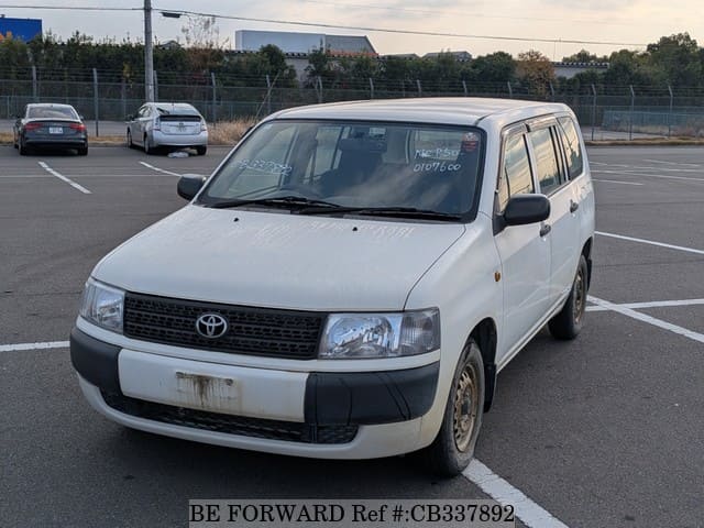 A grey JDM sports car speeding down a highway at night.