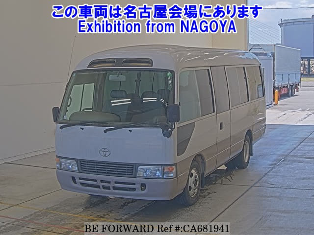 A grey JDM sports car speeding down a highway at night.