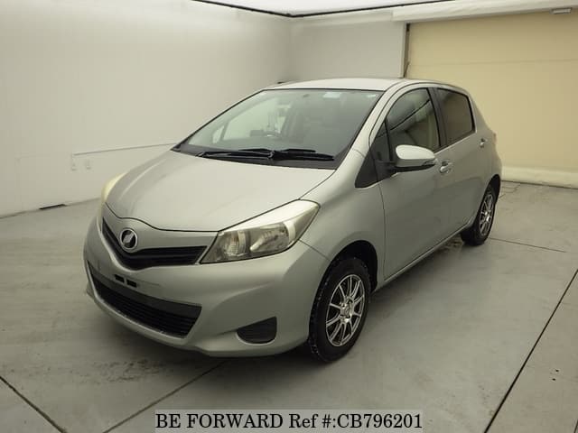 A grey JDM sports car speeding down a highway at night.