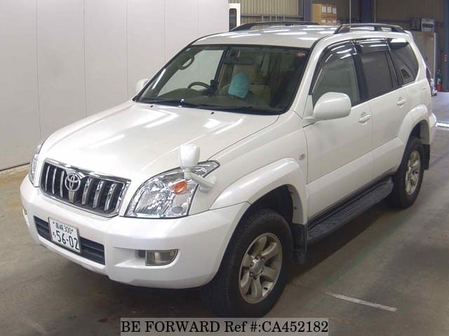 A grey JDM sports car speeding down a highway at night.
