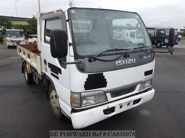 A grey JDM sports car speeding down a highway at night.