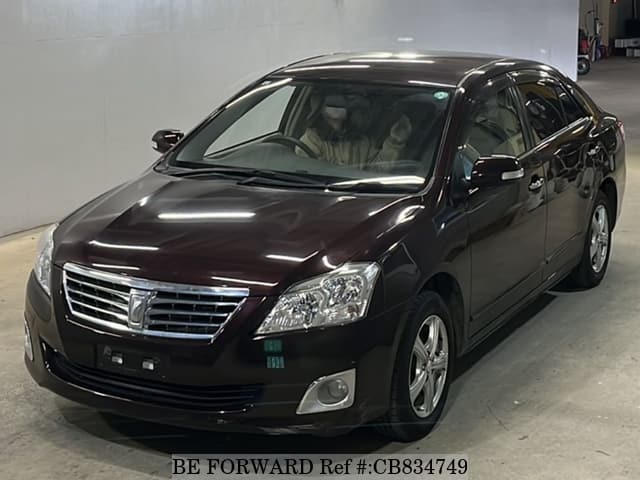 A grey JDM sports car speeding down a highway at night.
