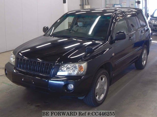 A grey JDM sports car speeding down a highway at night.