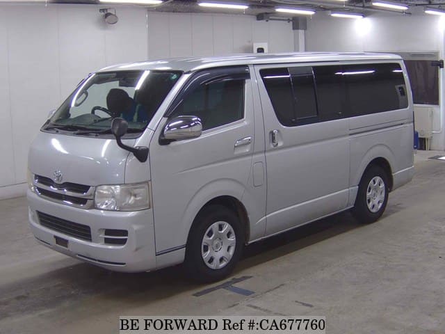 A grey JDM sports car speeding down a highway at night.
