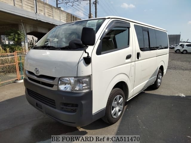 A grey JDM sports car speeding down a highway at night.