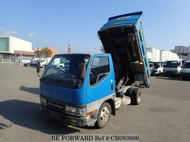 A grey JDM sports car speeding down a highway at night.