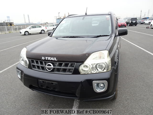 A grey JDM sports car speeding down a highway at night.