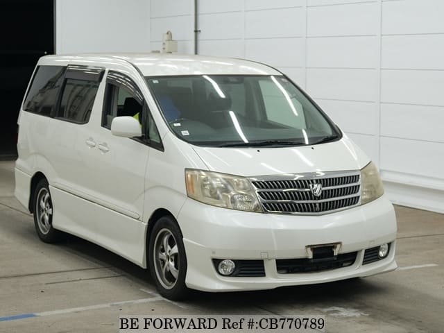 A grey JDM sports car speeding down a highway at night.
