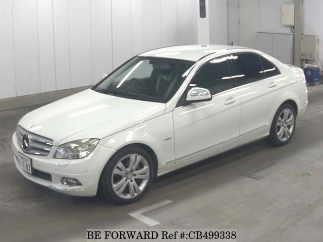 A grey JDM sports car speeding down a highway at night.