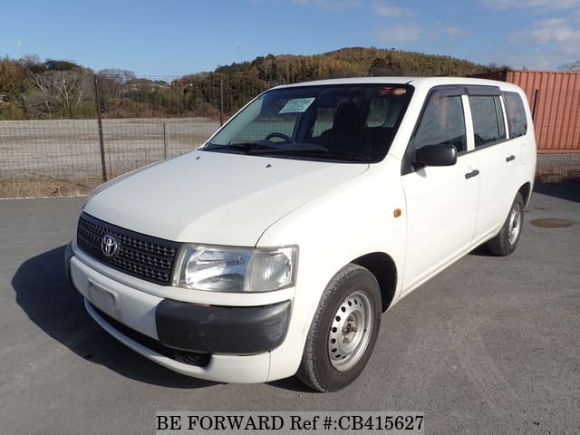 A grey JDM sports car speeding down a highway at night.
