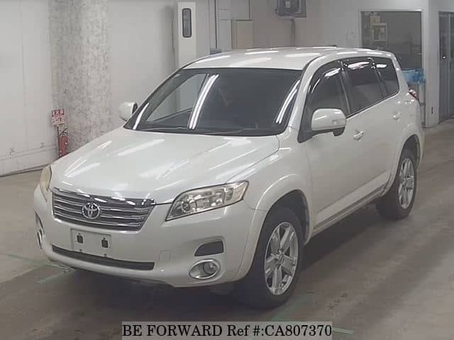 A grey JDM sports car speeding down a highway at night.