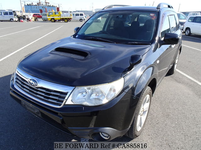 A grey JDM sports car speeding down a highway at night.