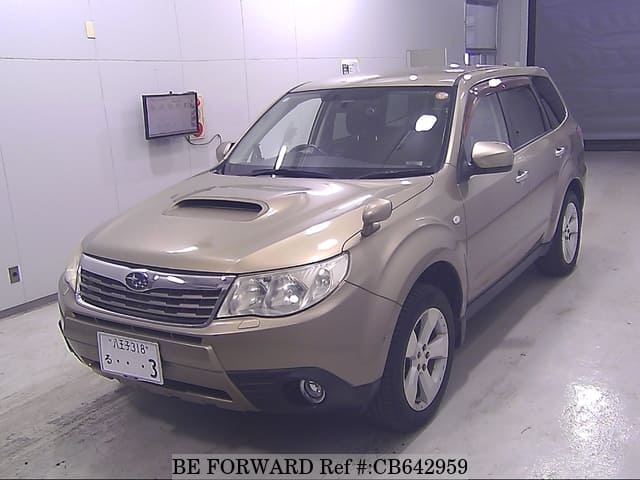 A grey JDM sports car speeding down a highway at night.