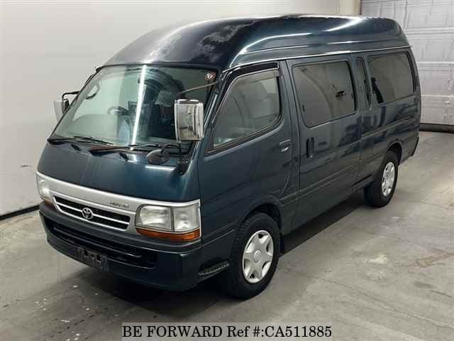 A grey JDM sports car speeding down a highway at night.