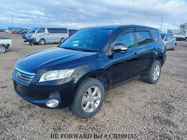 A grey JDM sports car speeding down a highway at night.