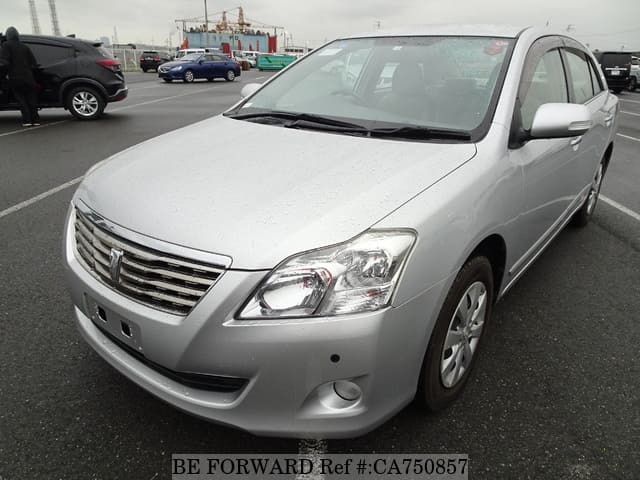 A grey JDM sports car speeding down a highway at night.