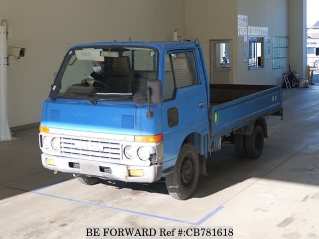 A grey JDM sports car speeding down a highway at night.