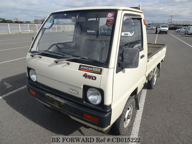 A grey JDM sports car speeding down a highway at night.