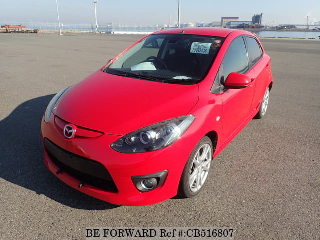 A grey JDM sports car speeding down a highway at night.