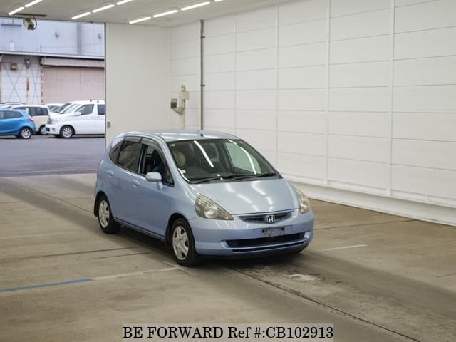 A grey JDM sports car speeding down a highway at night.