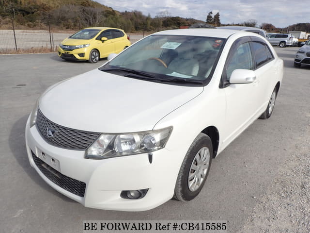 A grey sports car speeding down a highway at night.