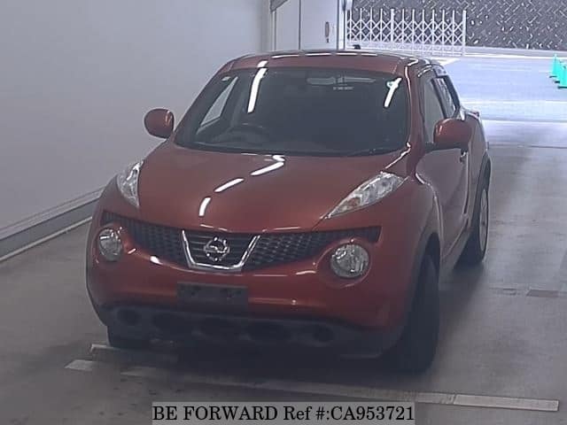 A grey JDM sports car speeding down a highway at night.