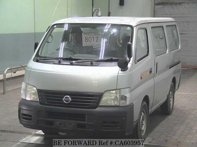 A grey JDM sports car speeding down a highway at night.
