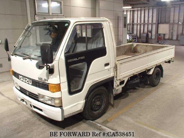 A grey JDM sports car speeding down a highway at night.