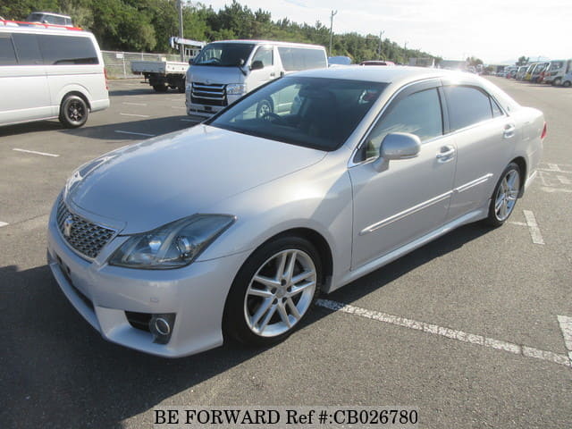 A grey JDM sports car speeding down a highway at night.