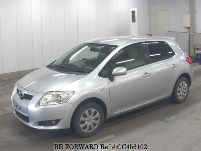 A grey JDM sports car speeding down a highway at night.