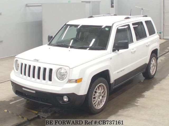 A grey JDM sports car speeding down a highway at night.