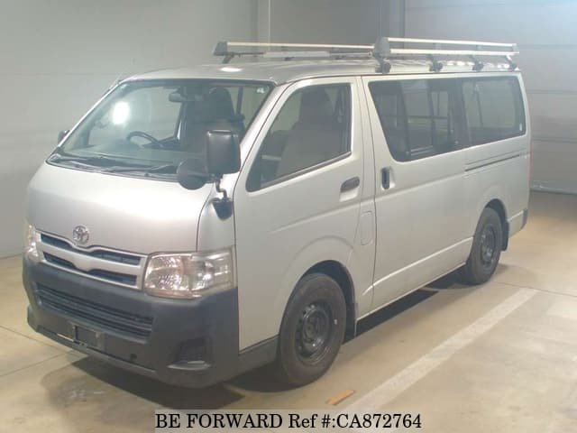 A grey JDM sports car speeding down a highway at night.