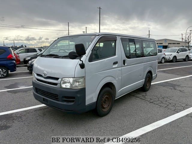 A grey JDM sports car speeding down a highway at night.