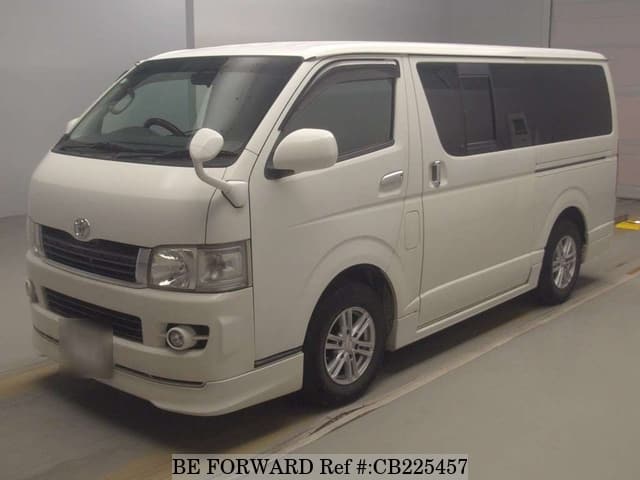 A grey JDM sports car speeding down a highway at night.