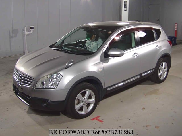 A grey JDM sports car speeding down a highway at night.