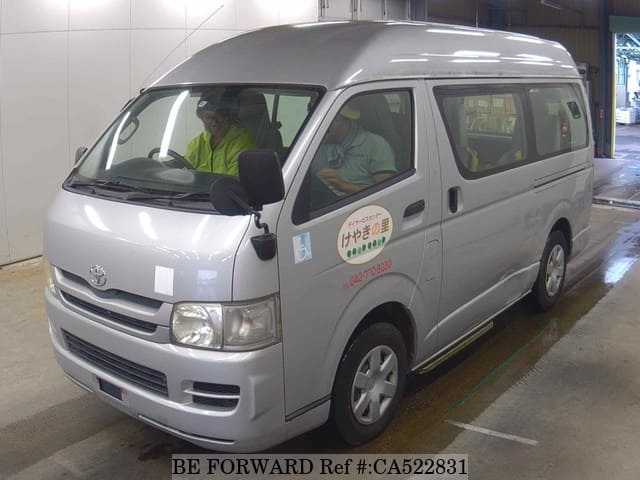 A grey JDM sports car speeding down a highway at night.