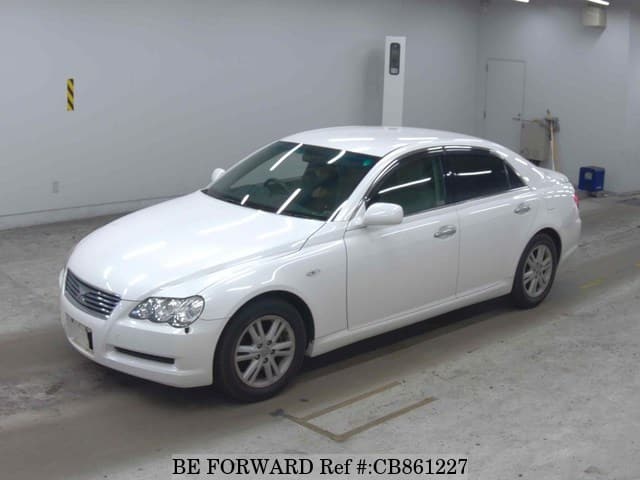 A grey JDM sports car speeding down a highway at night.