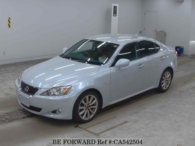 A grey JDM sports car speeding down a highway at night.