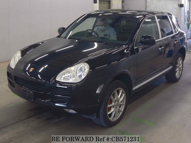 A grey JDM sports car speeding down a highway at night.