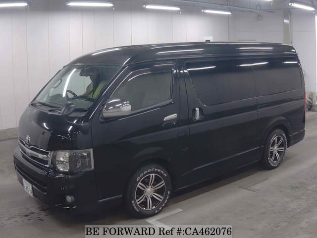 A grey JDM sports car speeding down a highway at night.