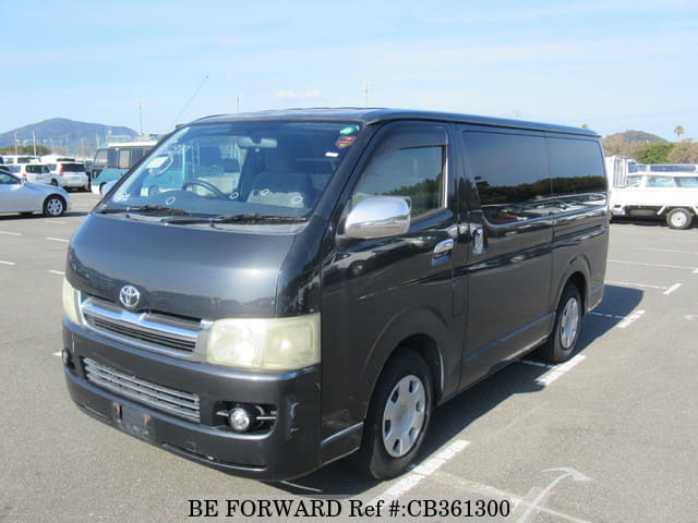 A grey JDM sports car speeding down a highway at night.