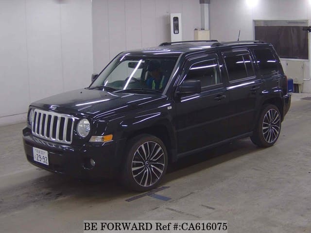 A grey JDM sports car speeding down a highway at night.